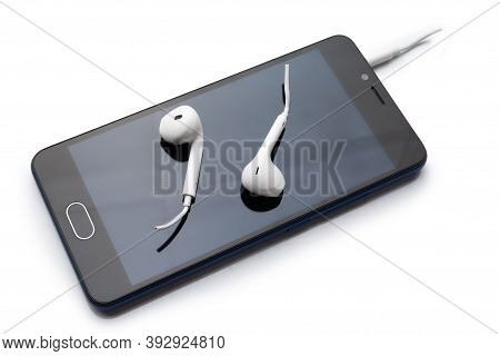 Conceptual Photo Of Cut Off The Earphones Wire. Bluetooth Headphones Are A New Trend. Wireless Techn