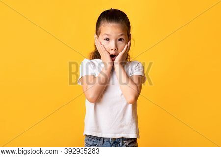 Reaction Concept. Portrait Of Surprised Speachless Chinese Kid With Amazed Facial Expression Touchin