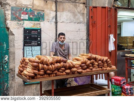 Jerusalem, Israel, October 24, 2020 : A Bakery Seller Stands Near His Wheelbarrow With Buns On Suq E