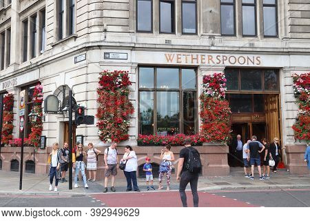 London, Uk - July 13, 2019: People Visit Wetherspoons Pub In London. It Is A Typical London Pub. The