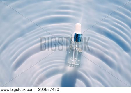 Cosmetic Spa Medical Skin Care, Bottle For Serum, Micellar Toner And Emulsion On Water Texture Backg