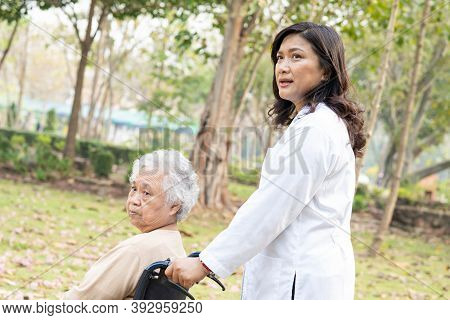Doctor Help And Care Asian Senior Or Elderly Old Lady Woman Patient Sitting On Wheelchair At Park In