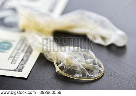 Used Condom And Us Dollars Bills. Cum In Condom. Prostitution Concept. Pay For Sex Per Night. Harlot