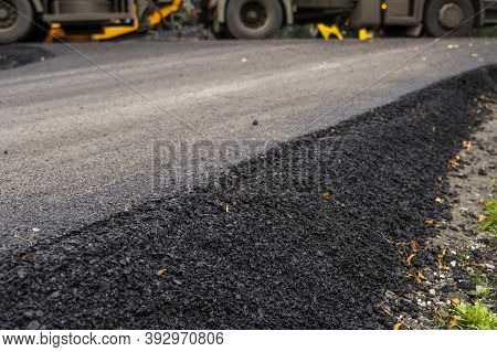 A Large Layer Of Fresh Hot Asphalt. Layer Of Asphalt Raw Material In A Shallow Depth Of Field. Rolle