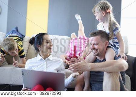 Family Mom Dad And Children Are Sitting Next To Sofa With Laptop Laughing And Indulging. Types Of Fa