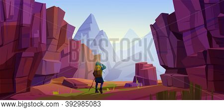 Traveler At Mountains, Travel Journey, Adventure. Tourist With Backpack And Map Stand At Rocky Lands
