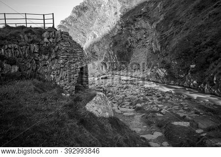 Long Exposure Of The River Heddon Flowing Onto The Beach At Heddons Mouth In Exmoor