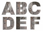 Old grunge metal alphabet letters isolated on white. From A to F.