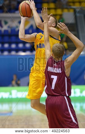KIEV, UKRAINE - AUGUST 8: V. Zotov, Ukraine and Renars Birkans, Latvia in action during U16 Eurobasket 2013 First round match Ukraine vs Latvia at Palace of Sport in Kiev, Ukraine on August 8, 2013
