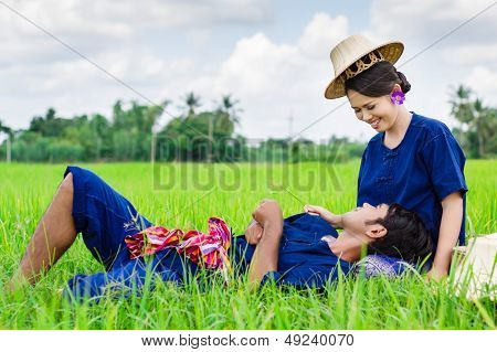 Farmer couple in farmer suits on rice fields