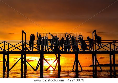 Large crowd of people against a sunset sky