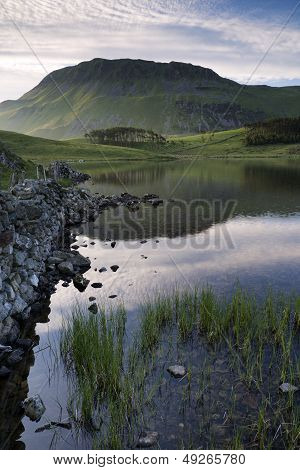 Beautiful Sunrise Mountain Landscape Reflected In Calm Lake