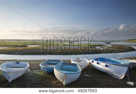 Small Leisure Boats Moored At Low Tide In Marina At Summer Sunset
