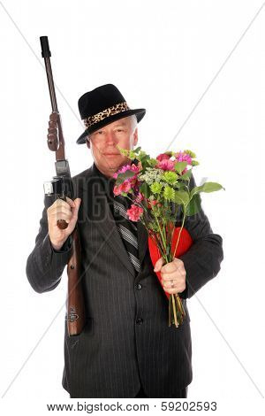 A 1920's era gangster in a pin stripe suit holds his Thompson Sub machine Gun while isolated on white with room for your text