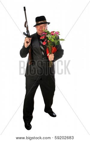 A 1920's era gangster in a pin stripe suit holds his Thompson Sub machine Gun while isolated on white with room for your text