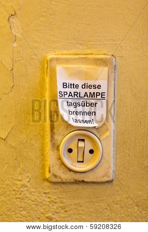 old light switch with label, let it burn saving lamp daytime