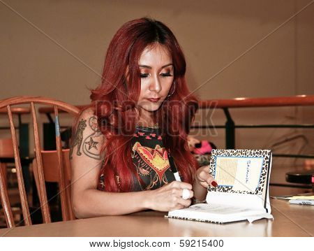 HUNTINGTON, NY-JAN 15: Reality star Nicole 'Snooki' Polizzi signs 'Baby Bumps:From Party Girl to Proud Mama and all the Messy Milestones Along the Way' at Book Revue on January 15, 2014 in Huntington.