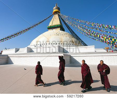 Nepal, Kathmandu -17Th Of December 2013: Tibetan Buddhist Monks Walking Around Boudhanath Stupa Duri