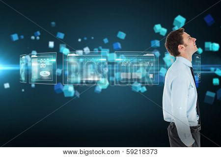 Happy businessman standing with hand in pocket against futuristic screen with quaders