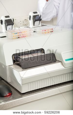 Microplates with biological samples on analyzer in laboratory