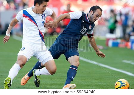 CARSON, CA. - FEB 01: Korea D Yong Lee #14 & USA M Landon Donovan #10 during the U.S. mens national team soccer friendly against Korea Republic on Feb 1st 2014 at the StubHub Center in Carson, Ca.