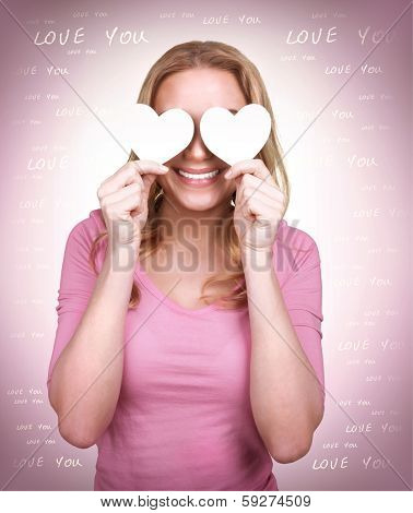 Portrait of cute loving girl with two hearts on the eyes, blind from love, isolated on pink background, happy Valentine day, affection concept