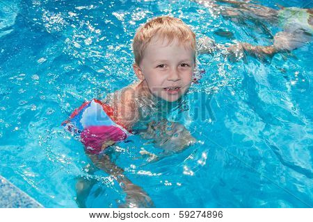 Boy Swims In The Pool