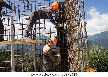 SOCHI, RUSSIA - JUNE 18, 2012: Workers make reinforcement for concrete wall