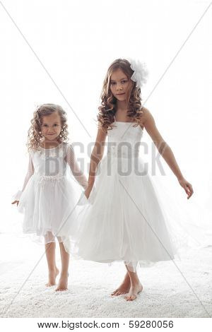 Beautiful little children wearing flower girl dresses