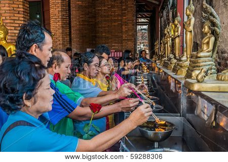 Bangkok, Thailand - December 29, 2013: people lighting incense at Wat Yai Chaimongkol in Ayutthaya