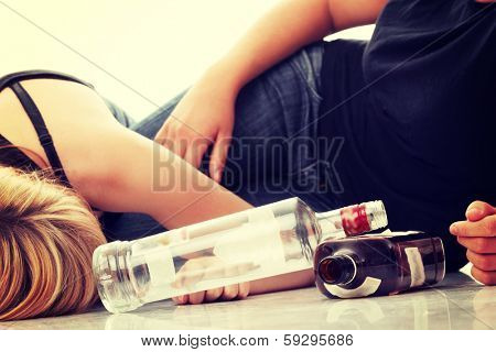 Teen alcohol addiction (drunk teens with vodka and whisky bottle)