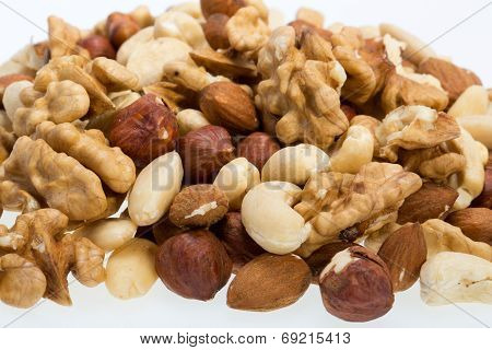 mixed nuts - hazelnuts walnuts cashews pine nuts isolated on white background