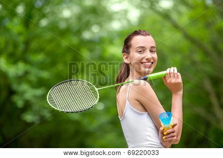 Sport Woman With Badminton Racket And Shuttlecock In The Park