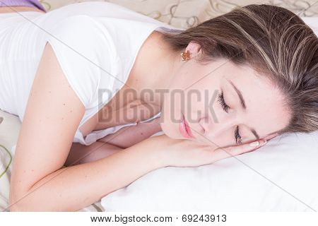 Attractive young woman in bed