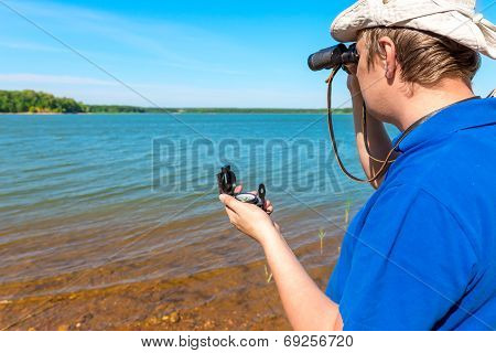 Errant Traveler With A Compass And Binoculars