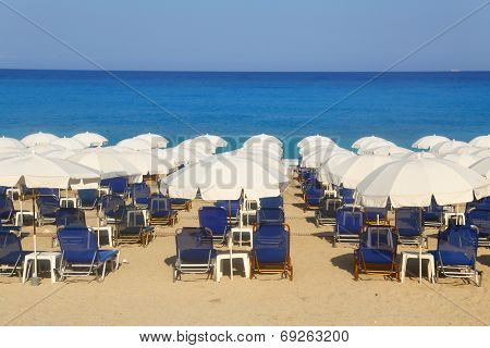 Sandy beach with white parasols and sunbeds Kathisma Lefkada 
