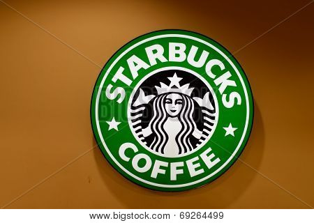 KUCHING - MAY 02: Starbucks cafe logo on May 02, 2014 in Kuching, Malaysia. Starbucks is the largest coffeehouse company in the world, with 23,187 stores in 64 countries