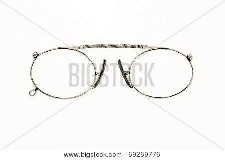Old Chromeplated Eyeglasses On A White Background