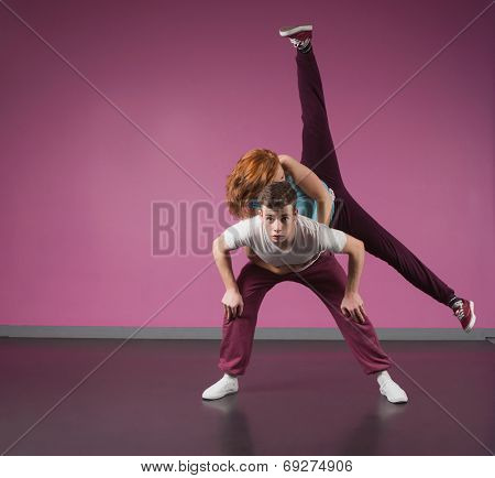 Cool break dancing couple dancing together in the dance studio