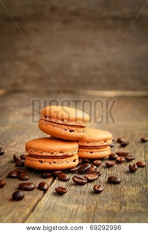 Row of coffee macarons on a table with coffee beans
