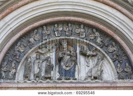 PARMA, ITALY - MAY 01, 2014: Virgin Mary with baby Jesus on the baptistery from Benedetto Antelami. Baptistery in Parma is considered to be among the most important Medieval monuments in Europe. 