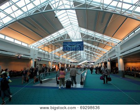People Walk Throught The Portland Airport