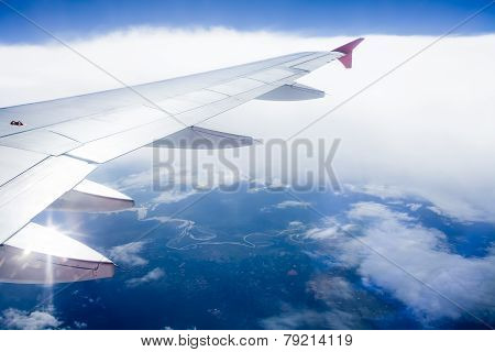 Wing Of An Airplane Flying Above The Clouds
