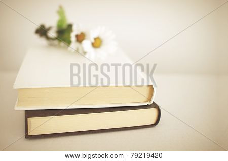 Two books adorned with flowers