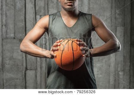 Afro-american basketball athlete gripping the ball