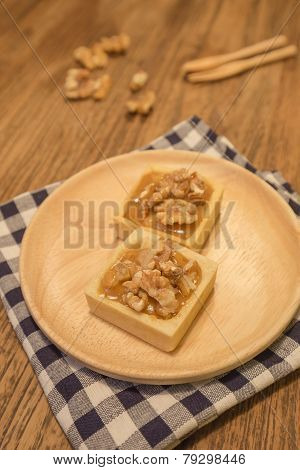 Fresh Delicious Caramel Nut Tart Dessert Presented Nicely On Wooden Plate.