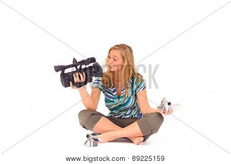 Studio shot of young blone woman with digital camcorder