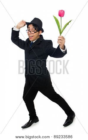 Young man in black costume with flower isolated on white
