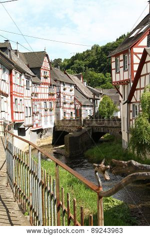 Creek lined with historic houses and wrought iron railing