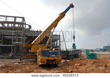 Mobile crane used to lifting heavy material at construction site